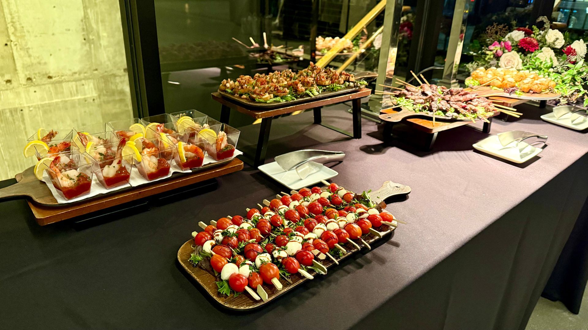 Buffet with various appetizers on wooden platters, including shrimp, tomatoes, and skewers.
With Love, Wedding management, Milwaukee Wedding Coordinator