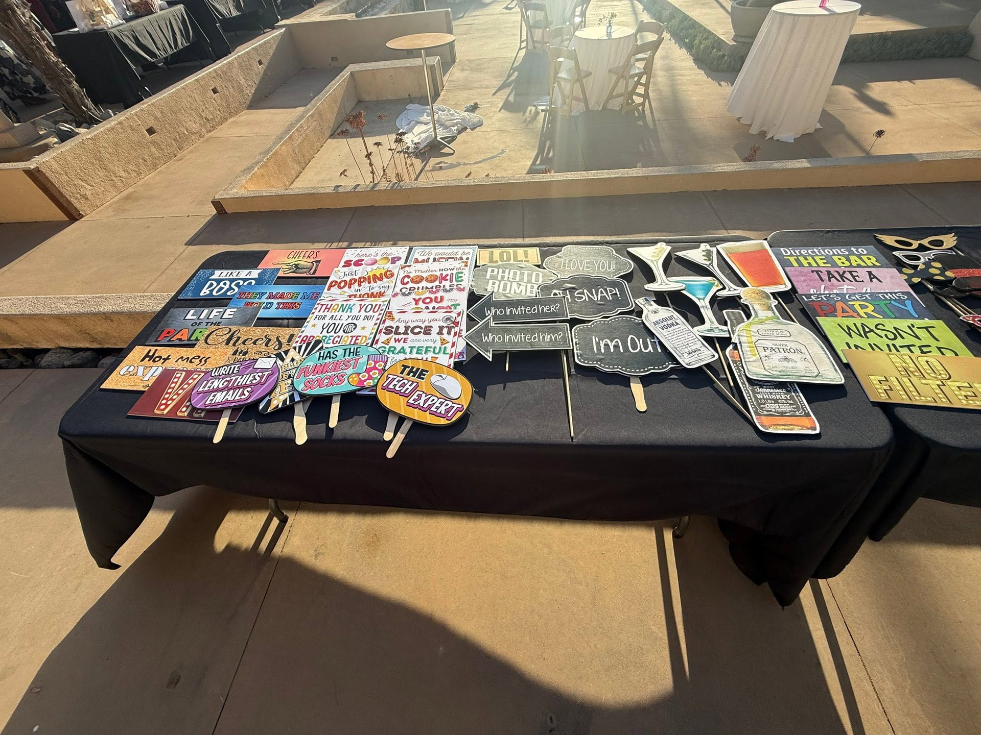 Table of colorful souvenir patches displayed outdoors in the sun.