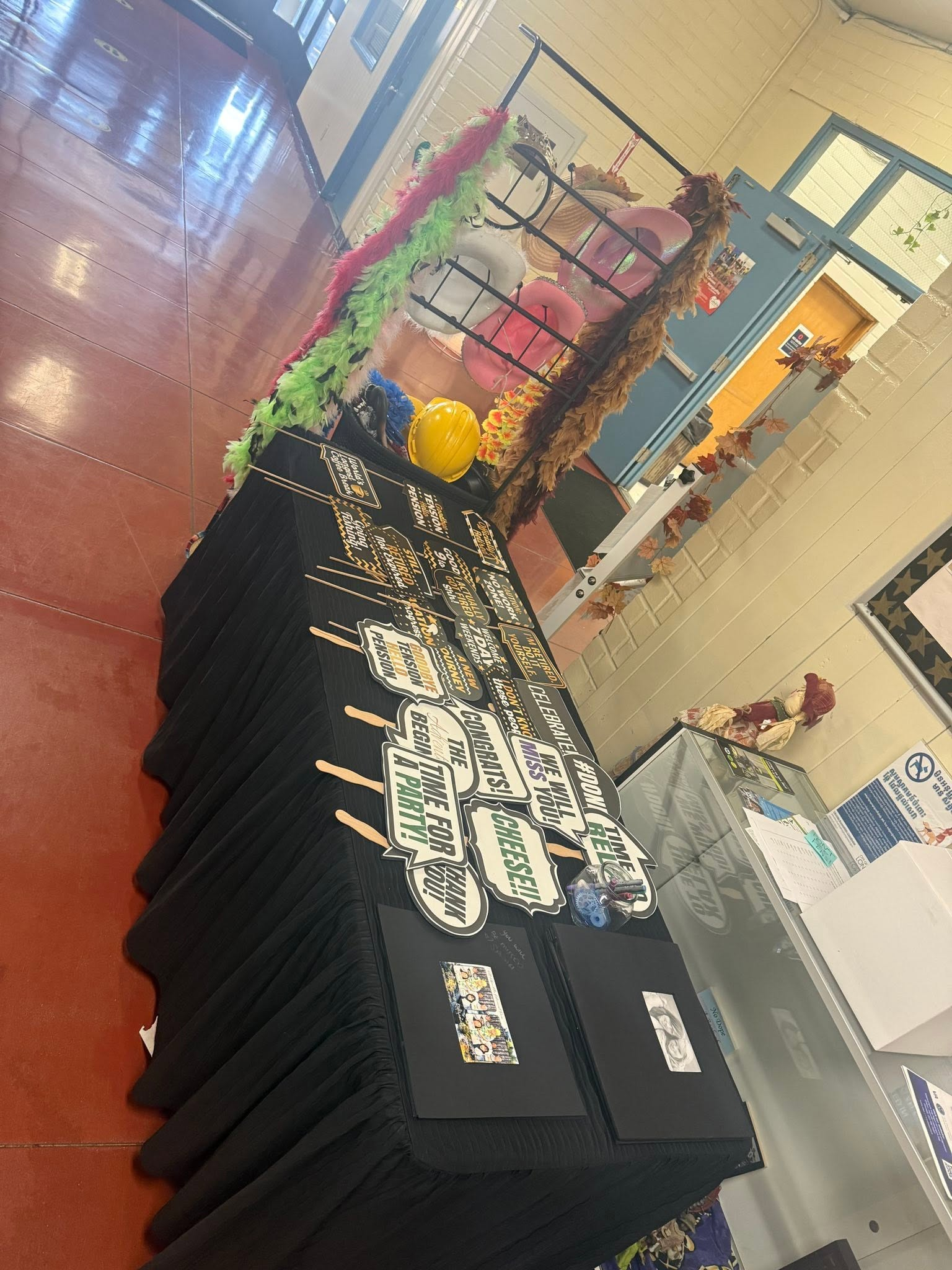 Display table with black shirts and colorful accessories in a store or market aisle