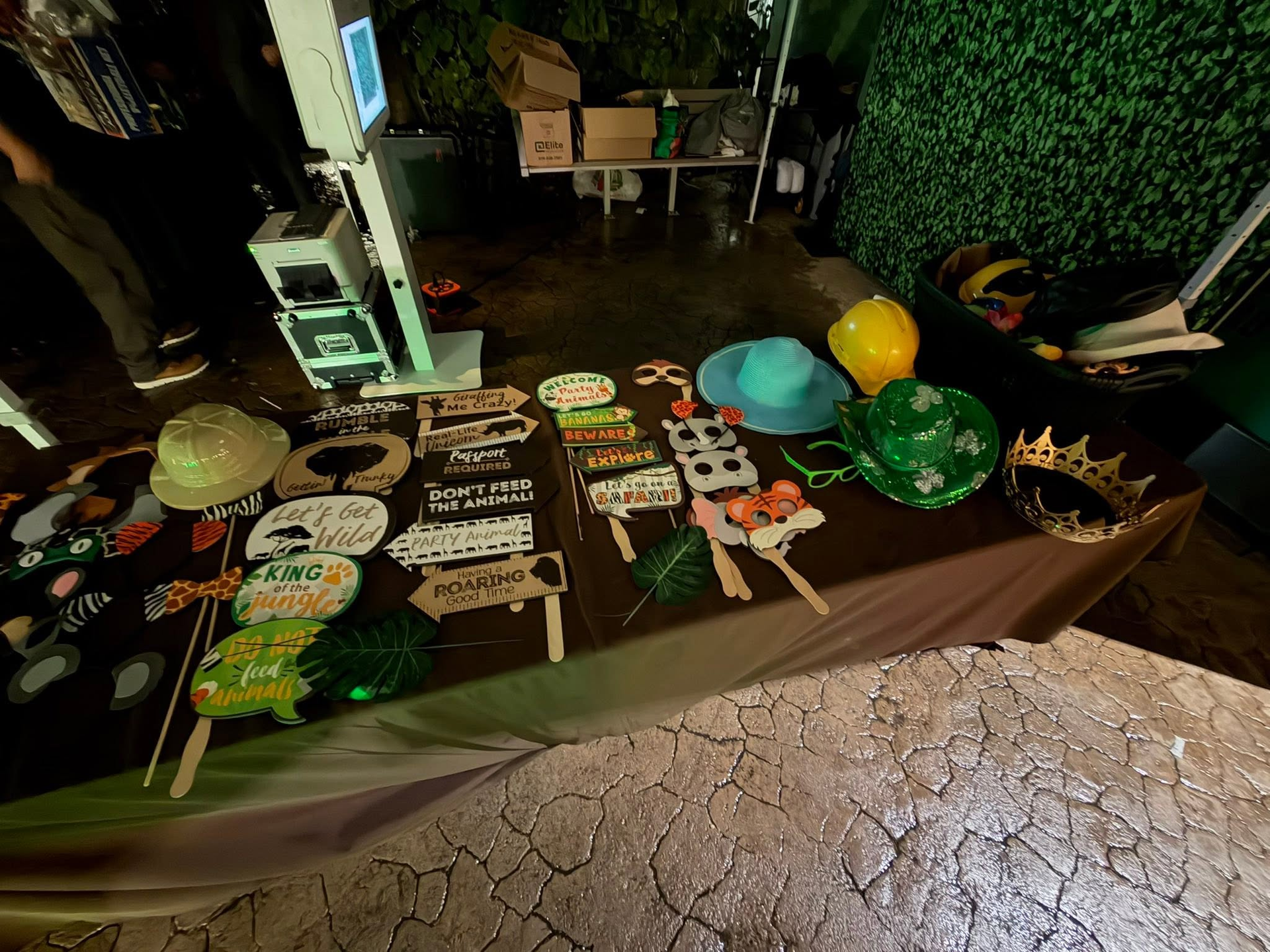 Table display of colorful handmade signs and balloons at an outdoor night market stall