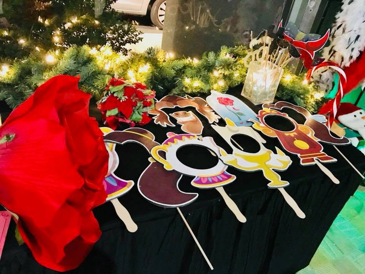 Holiday table display with oversized novelty glasses, red accents, and Christmas lights
