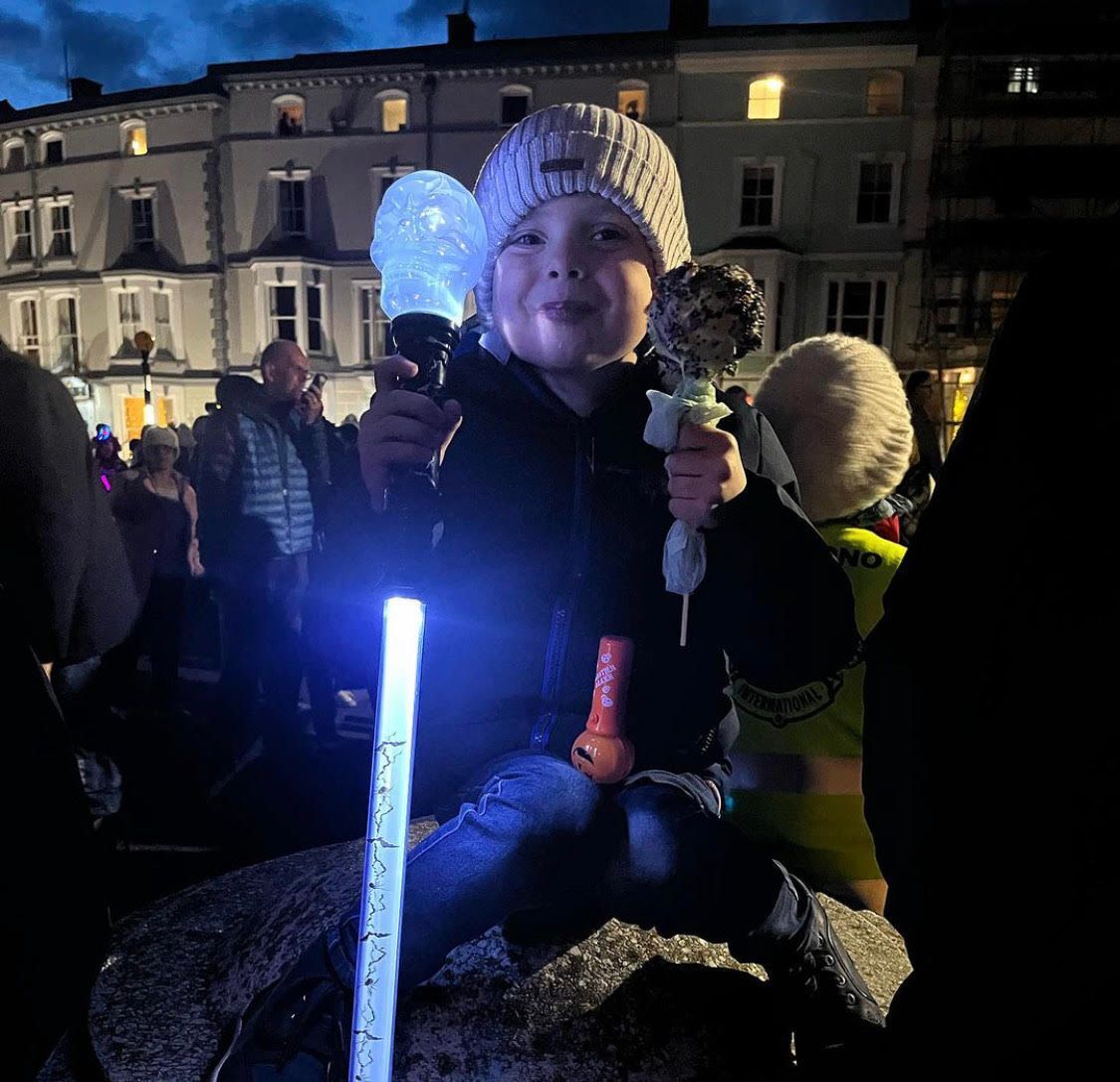 A little girl is holding a light stick in her hand