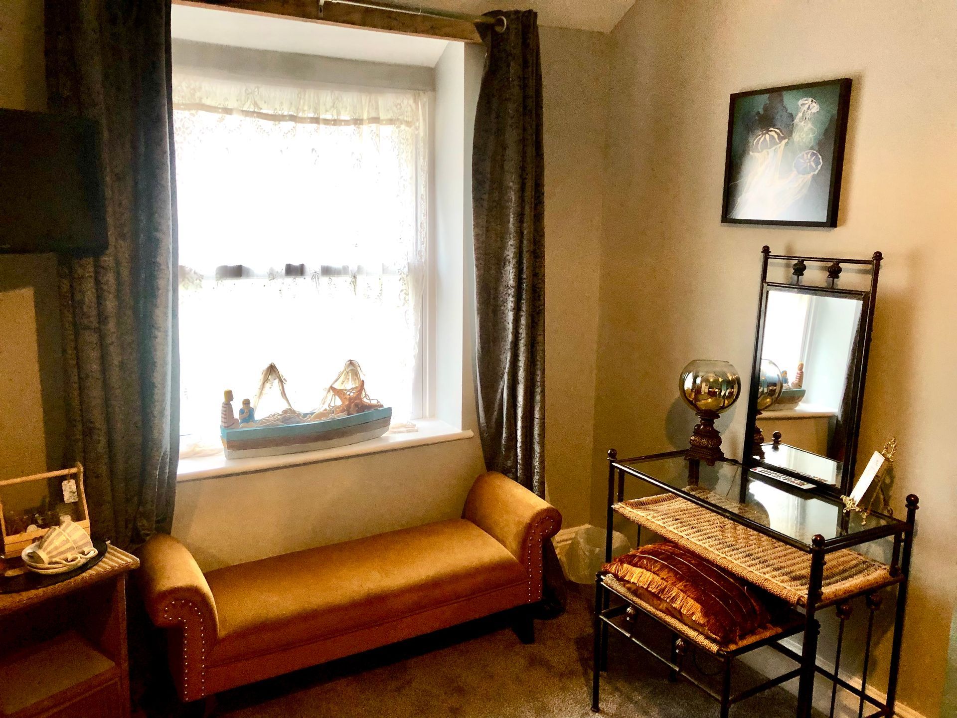A room with a bench and a mirror and a window