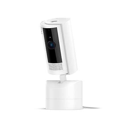 A white security camera is sitting on top of a white base on a white background.