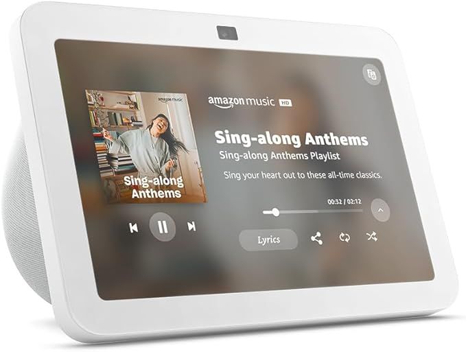 A white amazon echo show 8 is playing a song on its screen.
