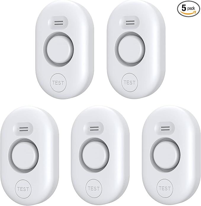 A set of six white remote controls with the words test on them.