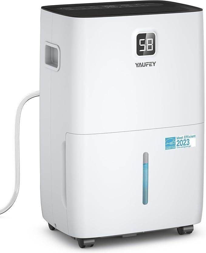 A white dehumidifier is sitting on a white surface.