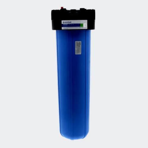 White water softener and gray storage tank in a basement utility area
