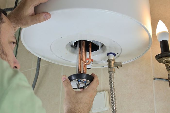 man repairing the heater coil