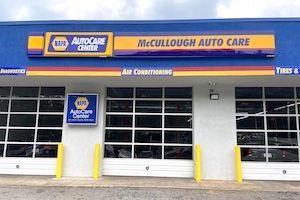 McCullough Auto Care storefront with blue awning and garage service bays