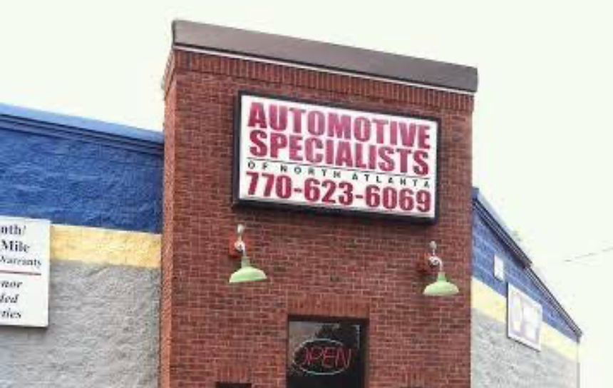 Brick storefront sign for Automotive Specialists, with phone number 770-623-6069 and an OPEN sign below