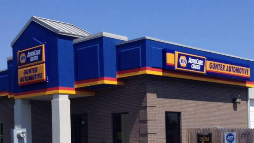AutoZone store exterior with blue and orange signage on a building corner.