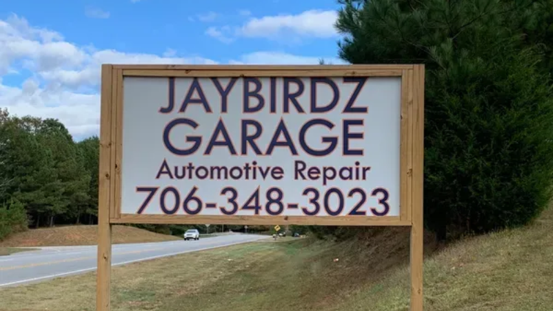 Jaybirdz Garage roadside sign for automotive repair, with phone number 706-348-3023.