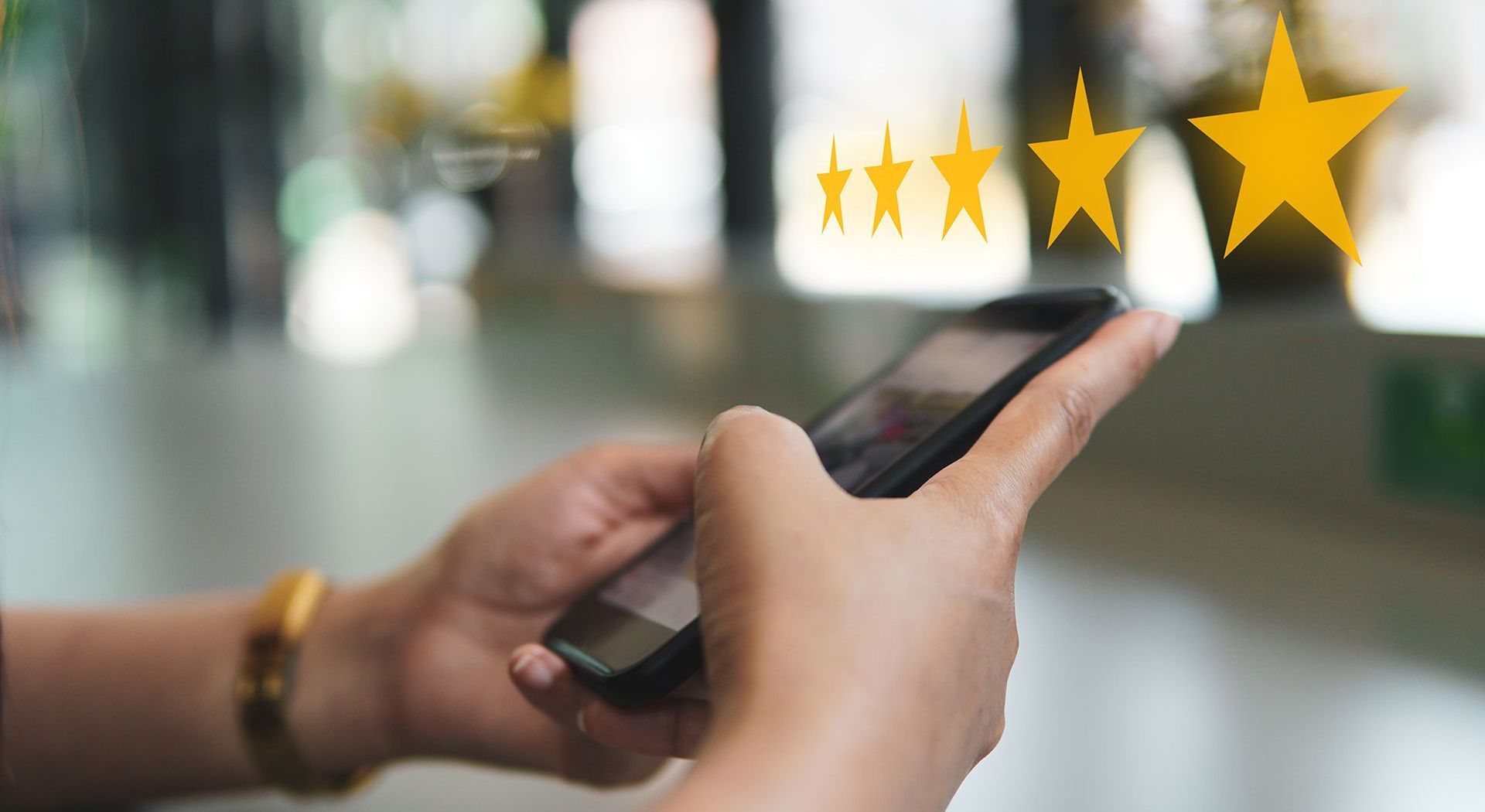 Person using a smartphone, giving a four-star rating.