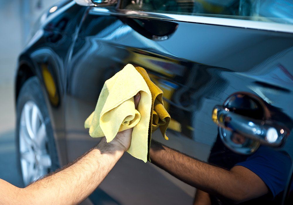 Person Cleaning The Car Exterior — Hutchinson, MN — Sullivan Mobile Detailing Person Cleaning The Car Exterior — Hutchinson, MN — Sullivan Mobile Detailing