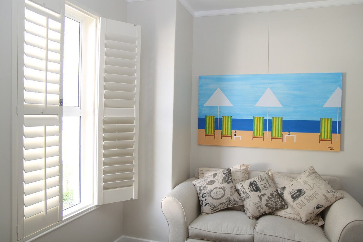 Living Room With White Window Shutters
