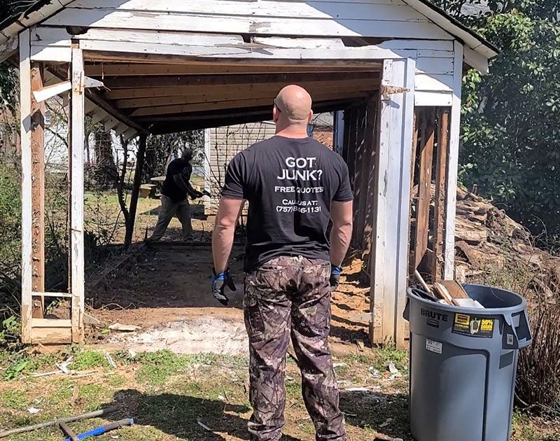 Junk Removal Expert assessing shed demolition job