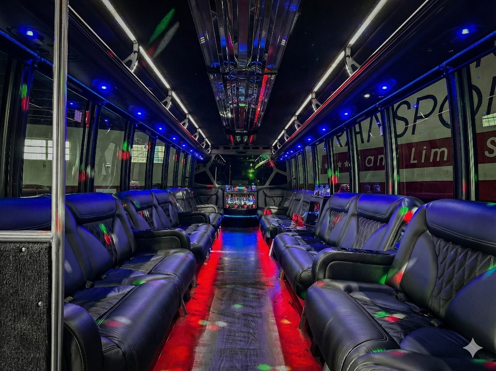 Luxury party bus interior with wraparound leather seating, LED accent lighting, beverage station, and open layout.