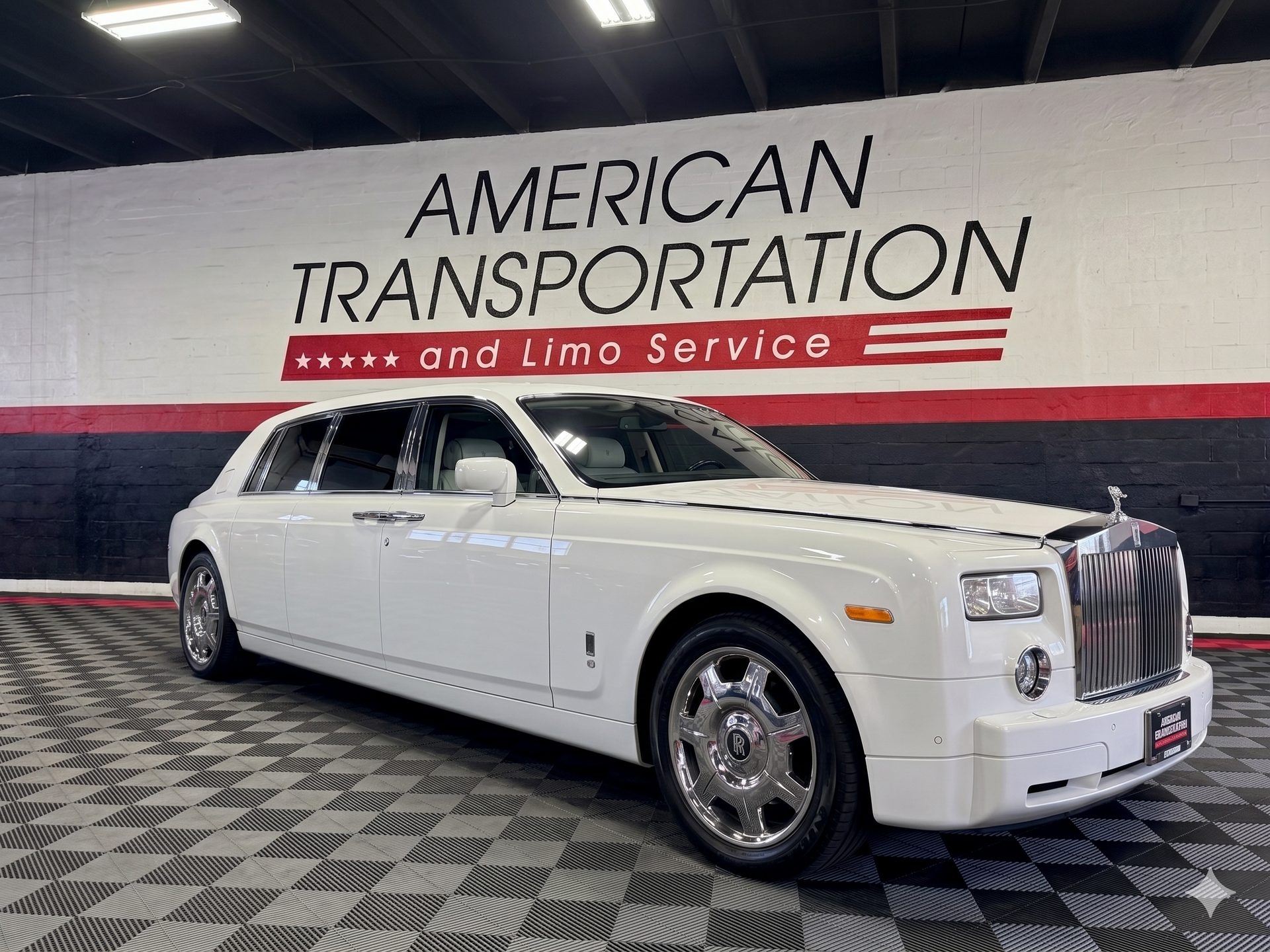 White Rolls-Royce Phantom parked in a showroom.