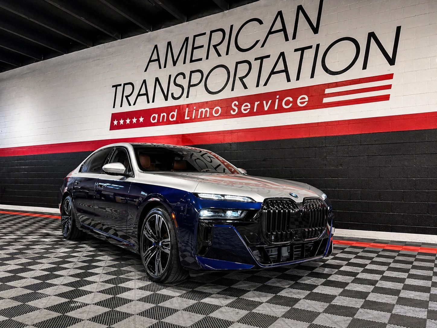 Blue and white BMW sedan parked inside the American Transportation facility