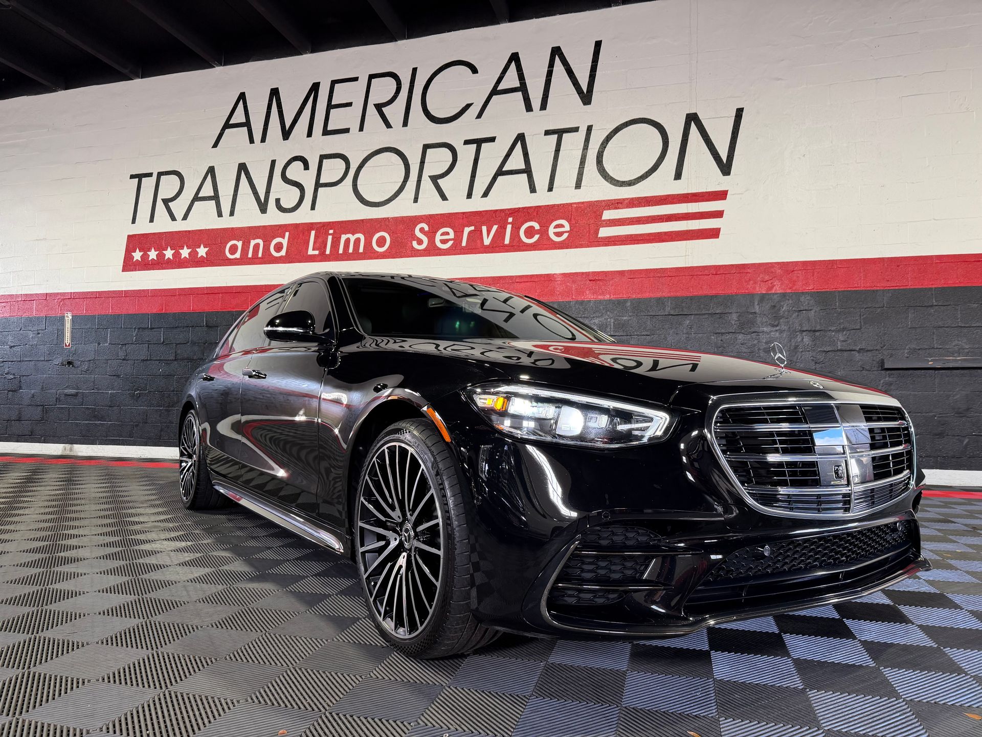 Black Mercedes-Benz sedan parked inside the American Transportation facility