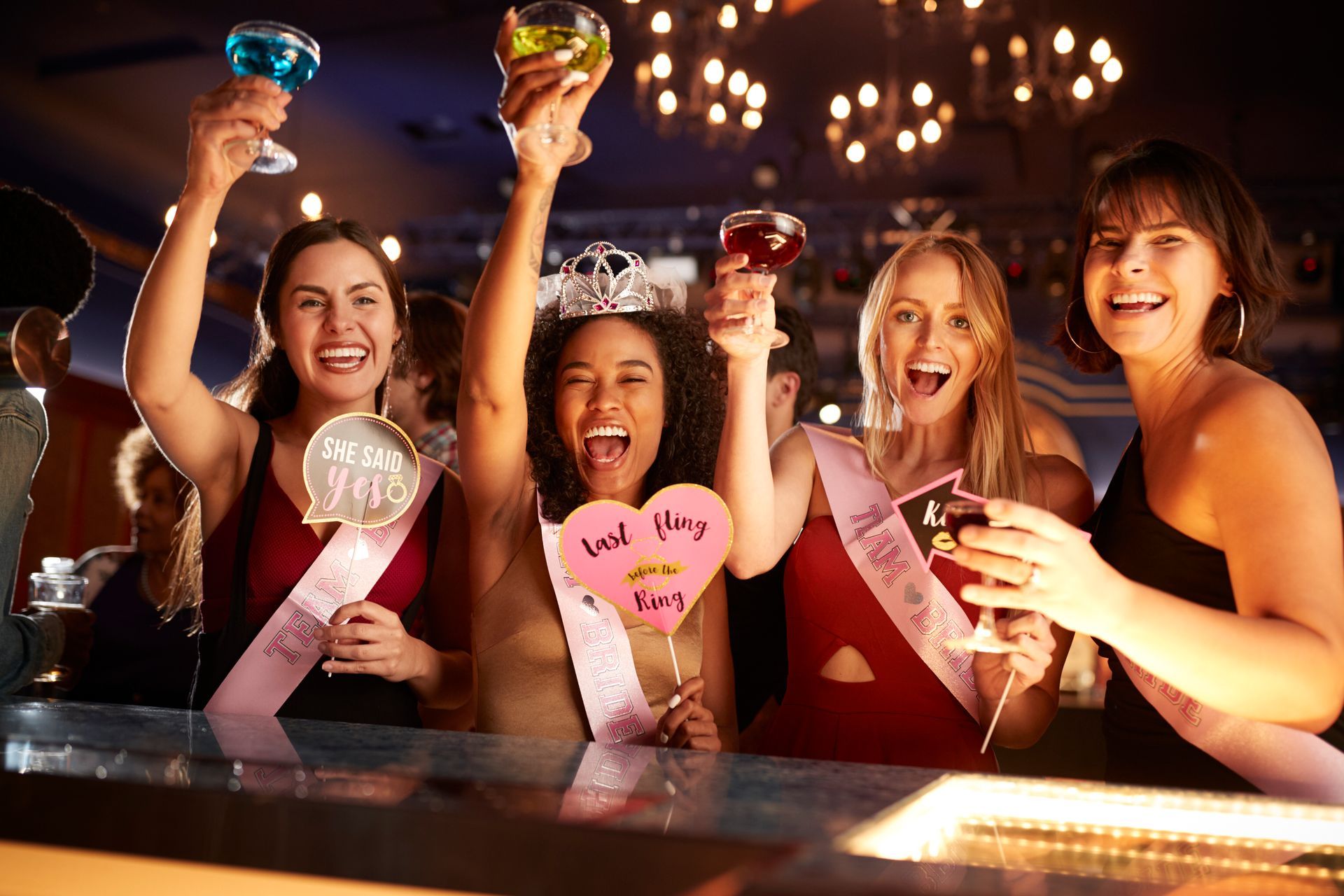 Bachelorette party celebrating with cocktails during a night out.