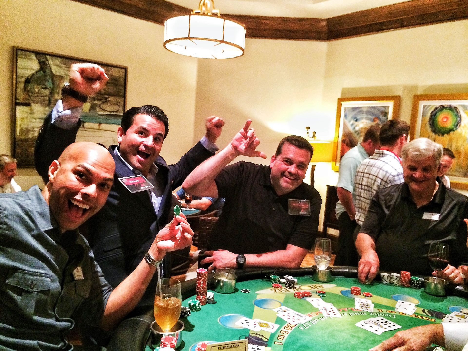a group of men enjoying a blackjack table. 