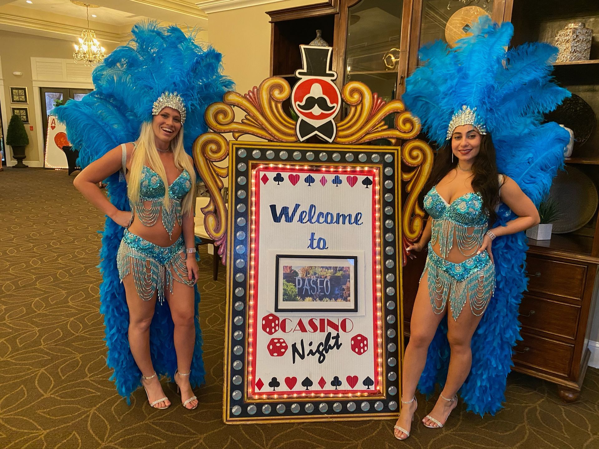 Welcome marquee sign with two Fabulous showgirls.