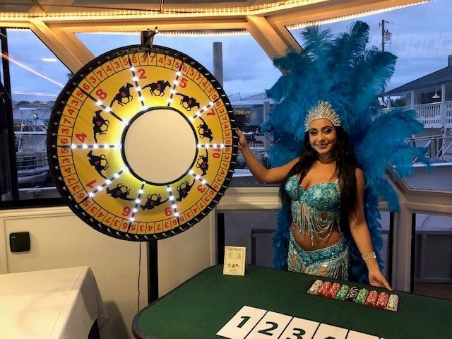 Showgirl dealing a lighted wheel of fortune.