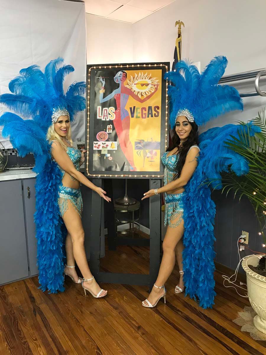 showgirls with Vegas themed casino decorations.