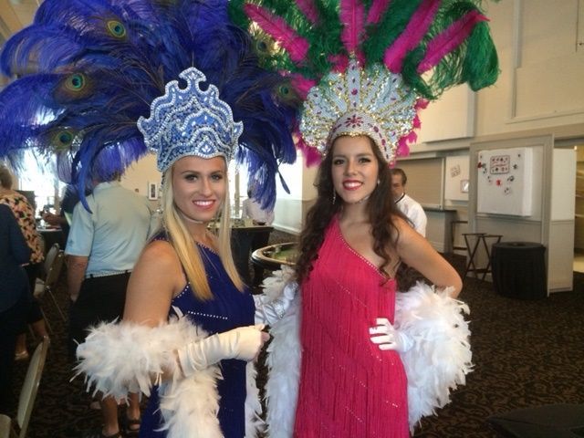 Showgirls greeting guests at a Gatsby themed event.
