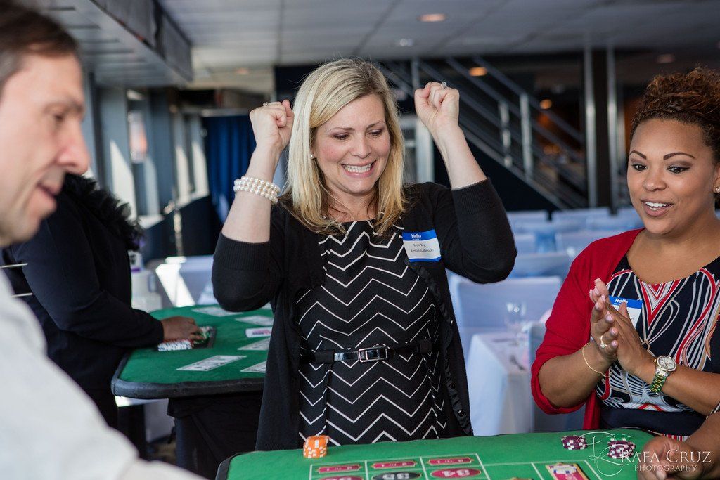 Guests enjoying the excitement of winning at a casino party. 