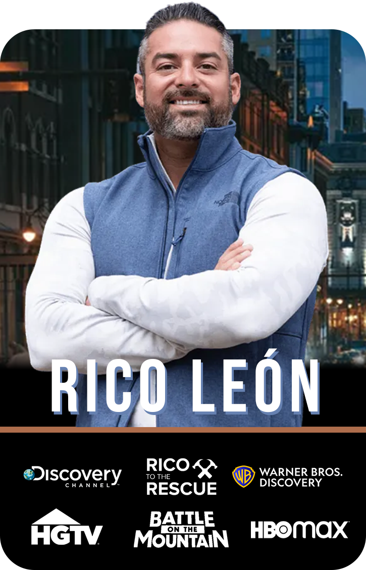 Ric with his arms crossed is wearing a blue vest .