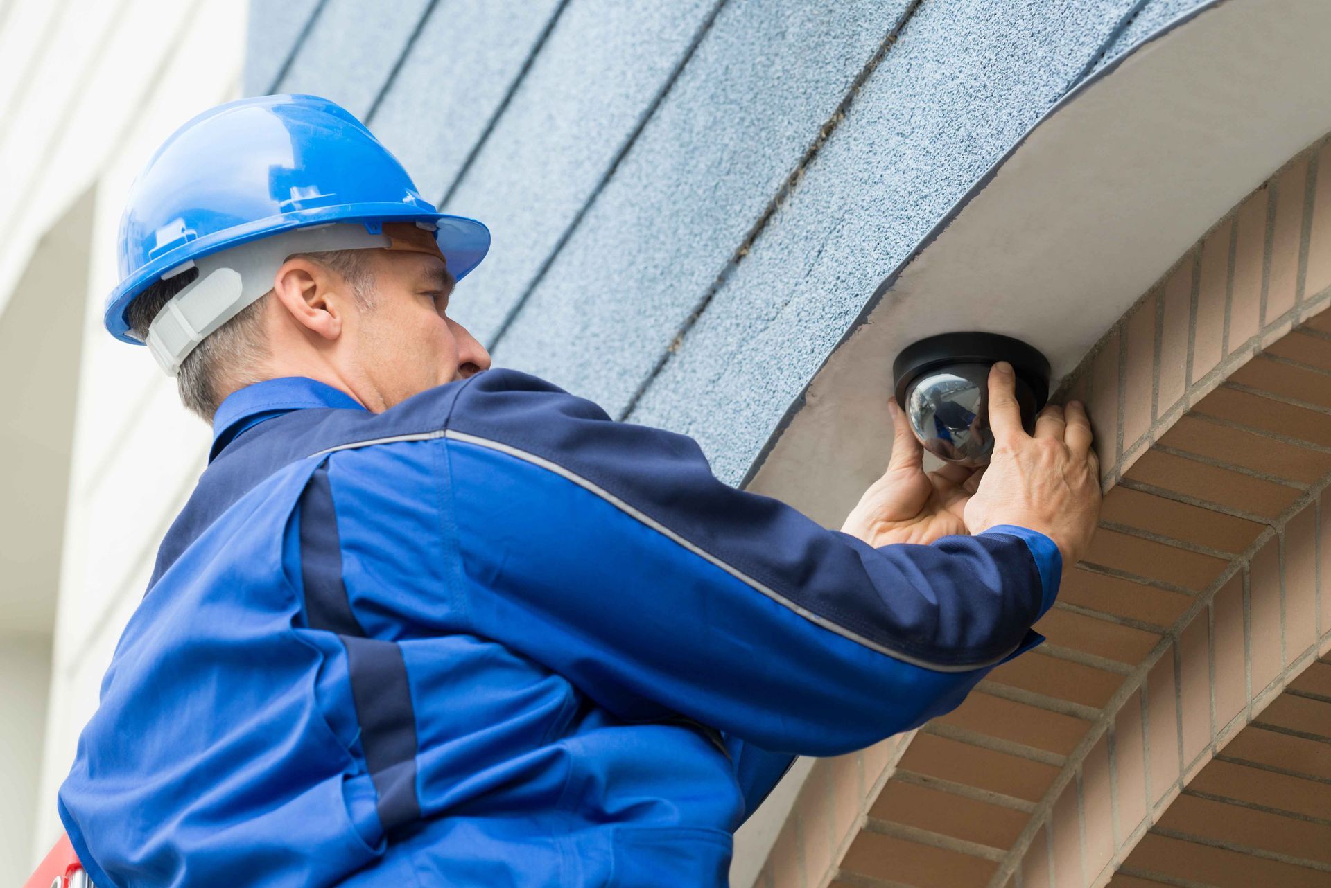 Man installing a security camera
