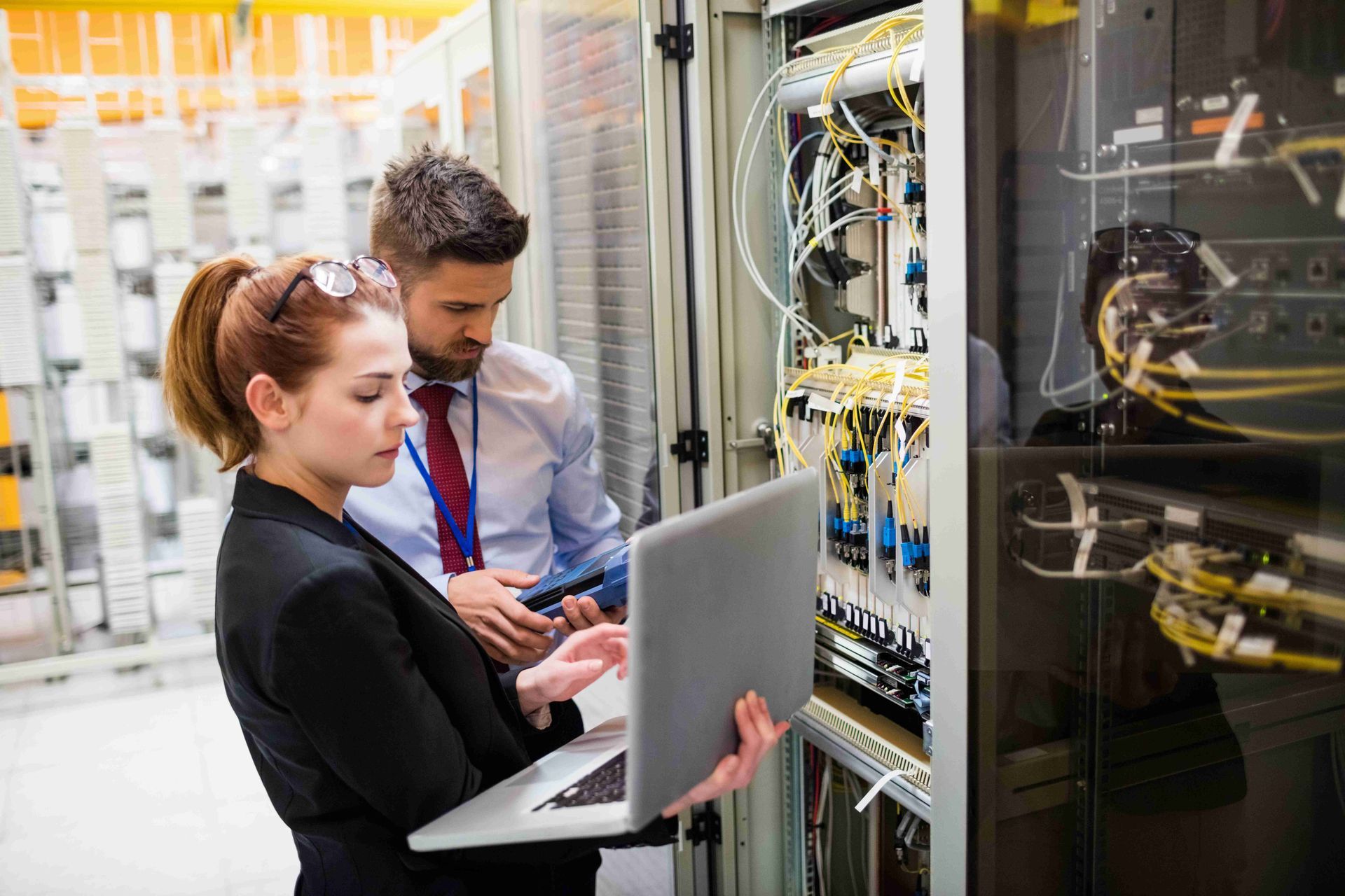 Man and woman checking the network cables