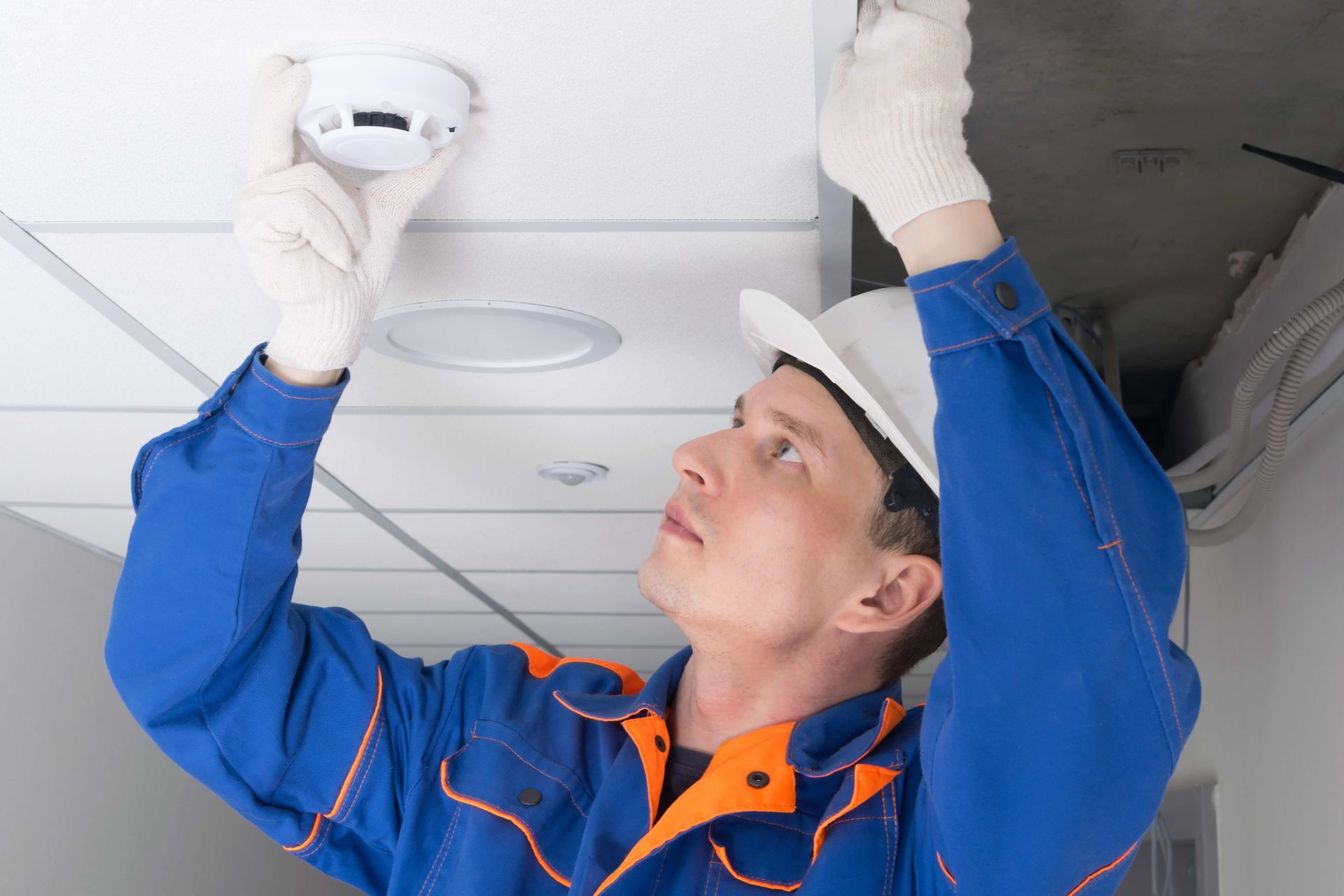Man installing fire alarm