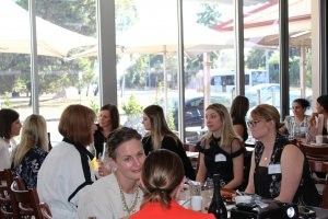 A group of women are sitting at a table in a restaurant.