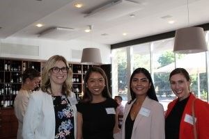 A group of women are posing for a picture in a restaurant.