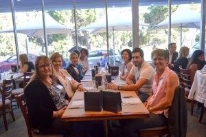 A group of people are sitting at a table in a restaurant.
