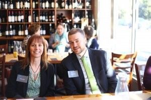 A man and a woman are sitting at a table in a restaurant.