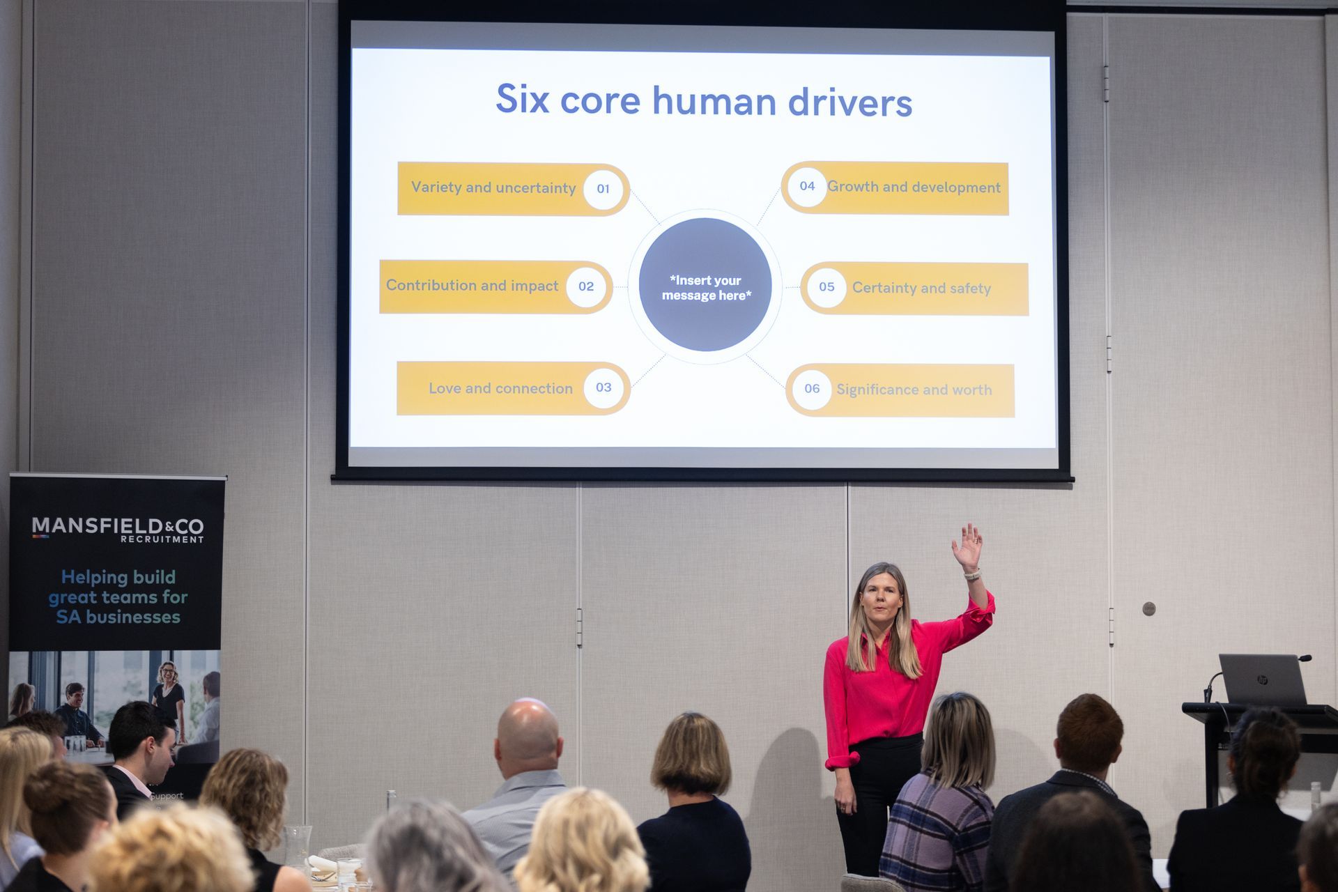 A woman is giving a presentation to a group of people.