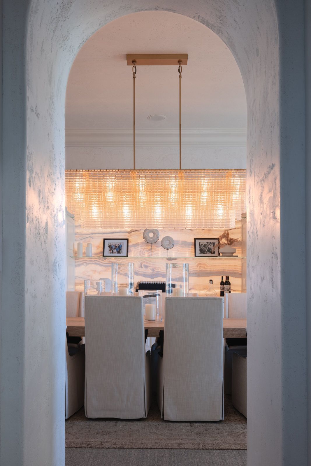 A dining room with a table and chairs and a chandelier