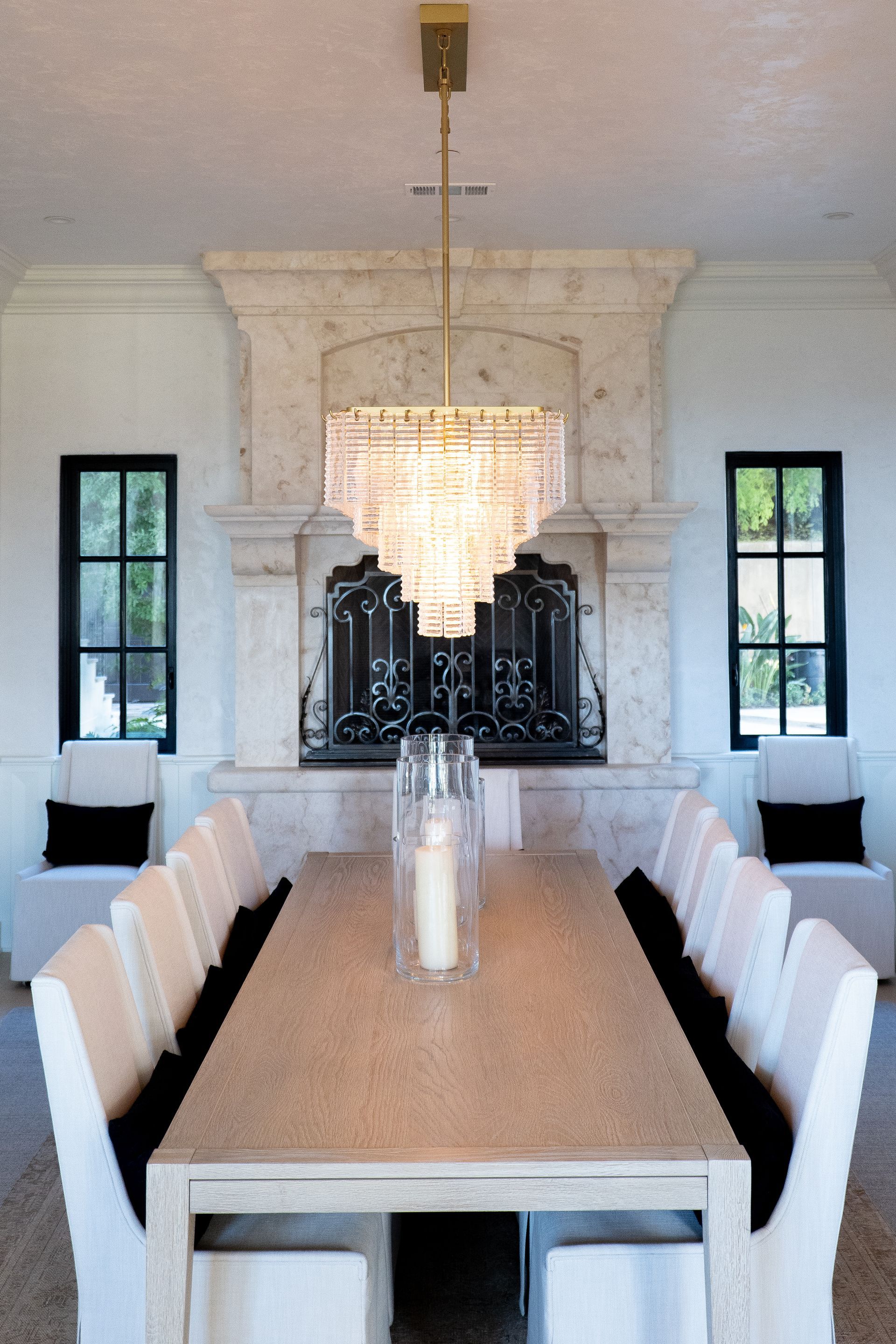 A dining room with a table and chairs and a fireplace