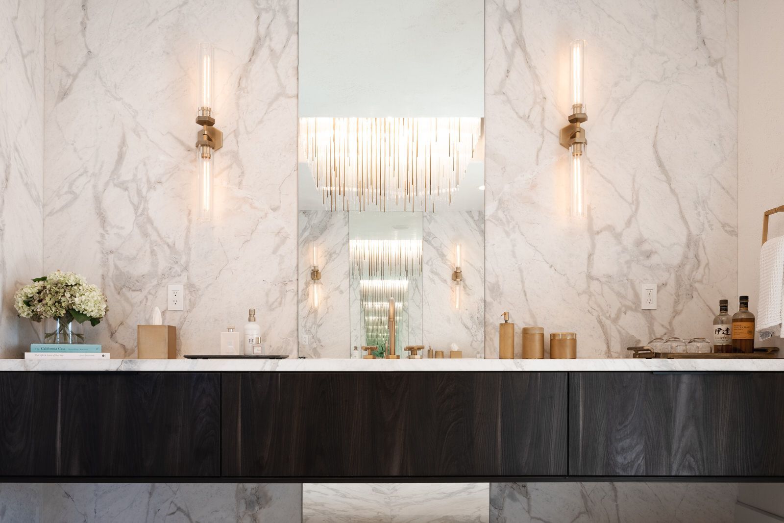 A bathroom with two sinks and a large mirror.