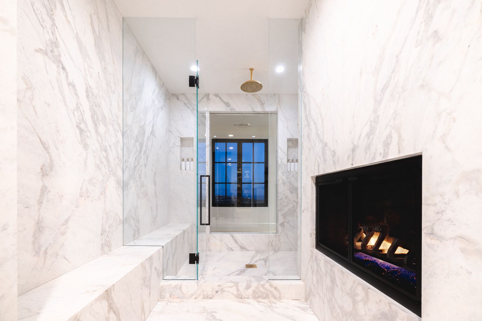 A bathroom with a fireplace and a walk in shower.