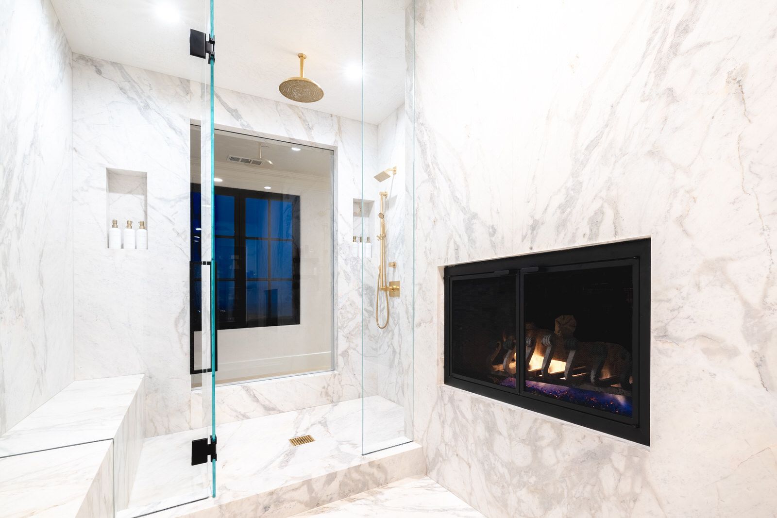 A bathroom with a fireplace and a walk in shower.