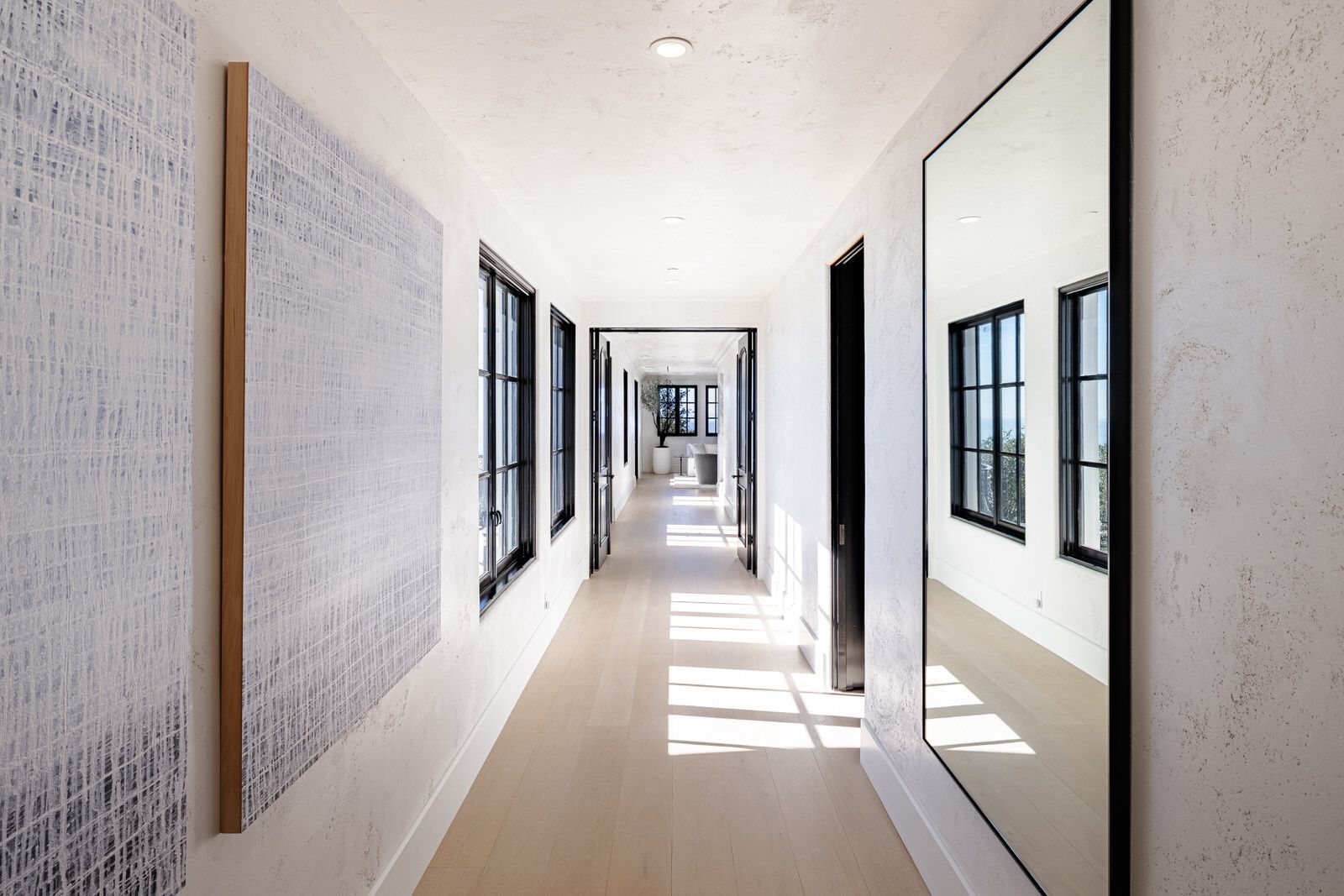 A long hallway with a large mirror on the wall