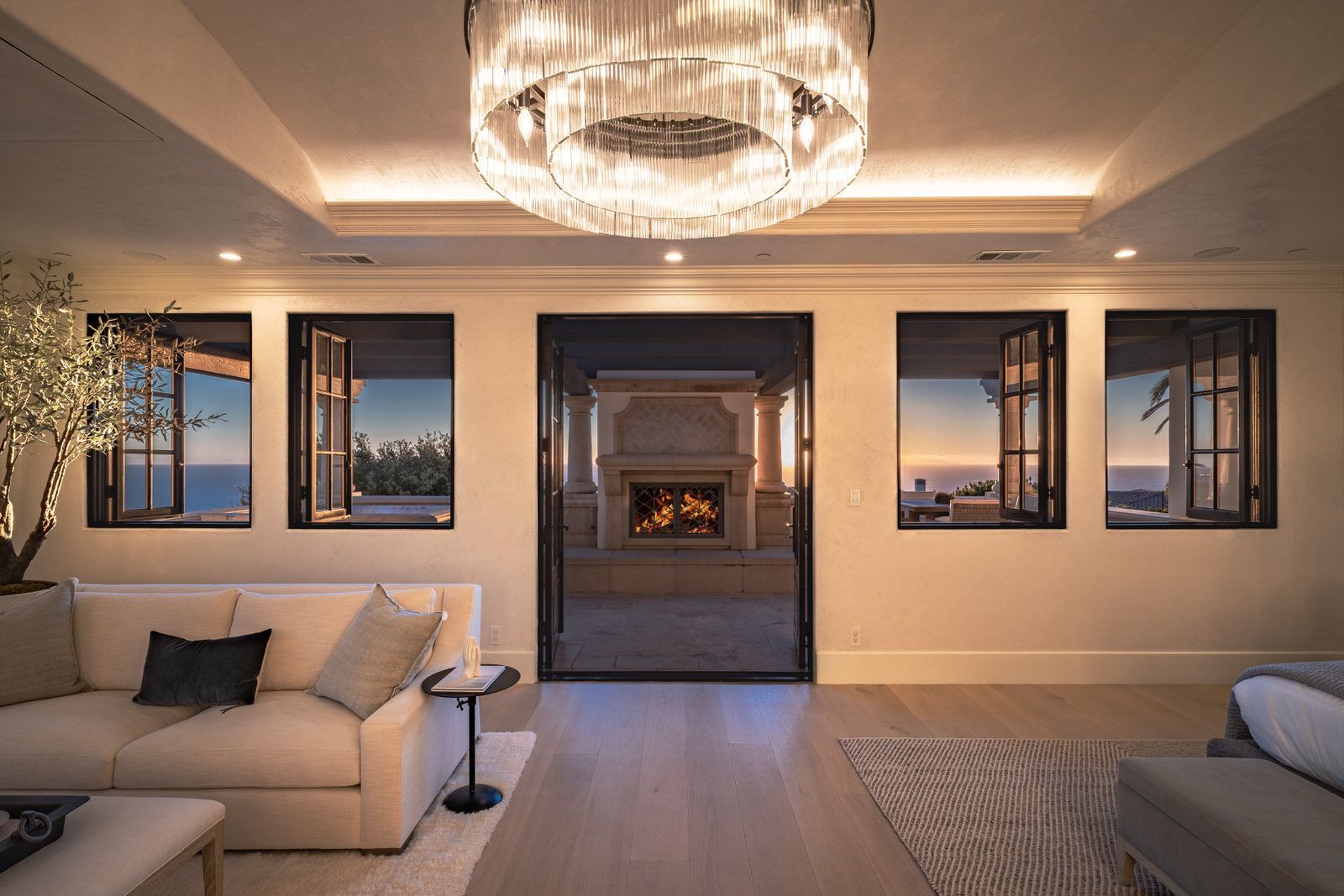 A living room with a fireplace and a chandelier