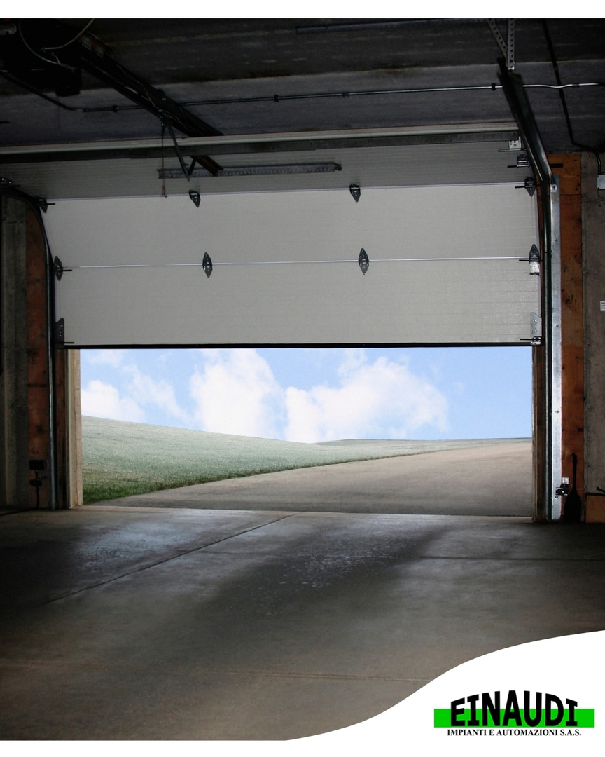Porta del garage aperta con cielo limpido visibile sopra il pavimento di cemento