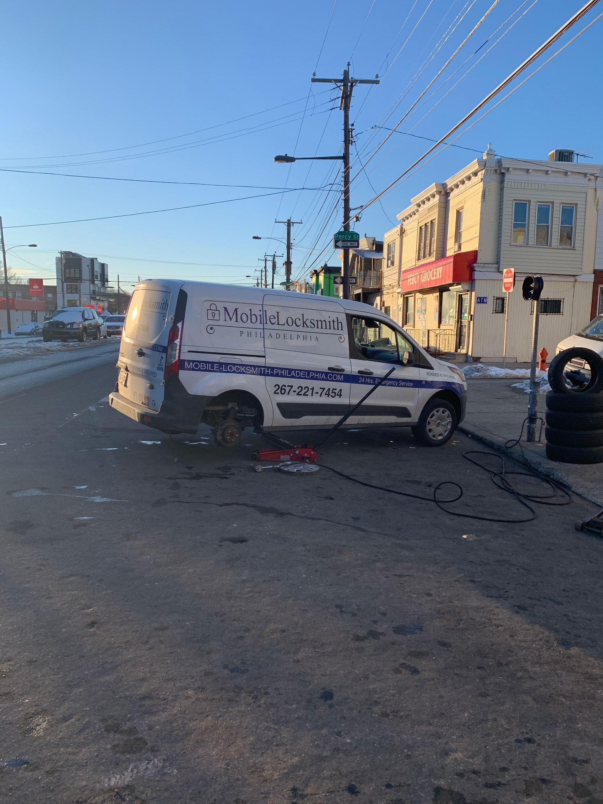 White van with Arabic text parked in a damaged street intersection, debris scattered nearby.